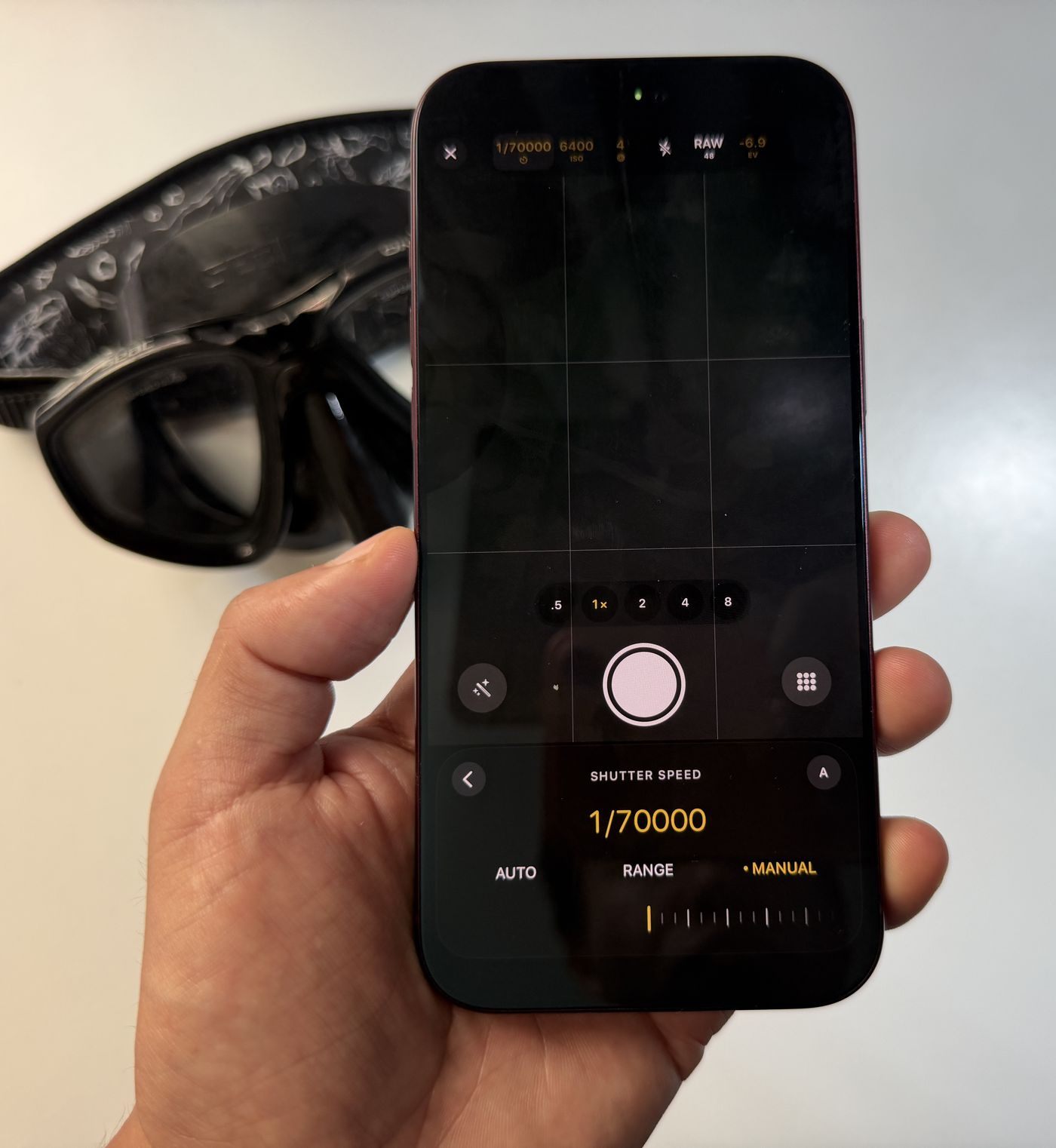 An iPhone 18 Pro Max in a hand, showing the Diving Standard camera with the shutter speed set to 1/70000 of a second